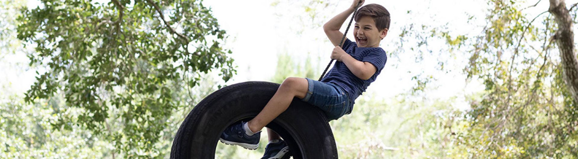 a child swinging on a tire swing