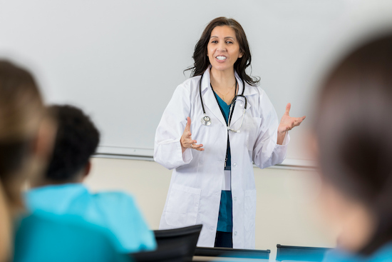 Female doctor standing in front of a classroom of students