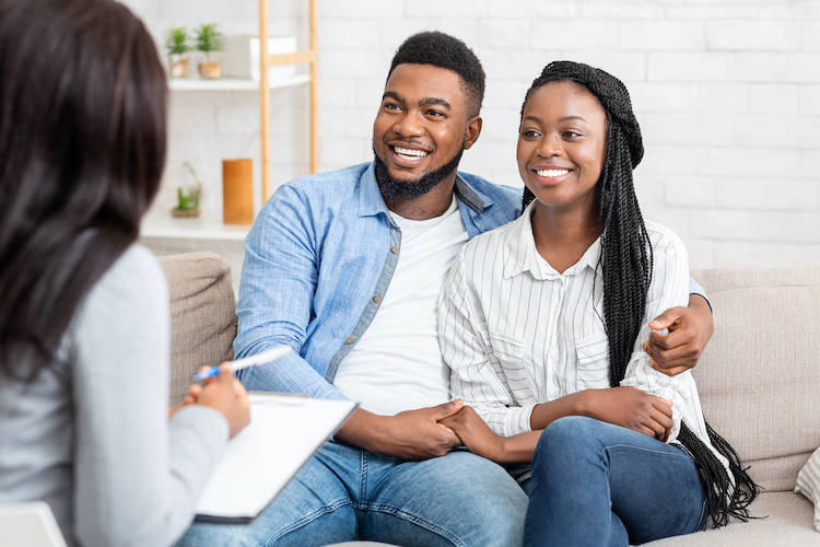 Counselor and happy african american couple after successful marital therapy
